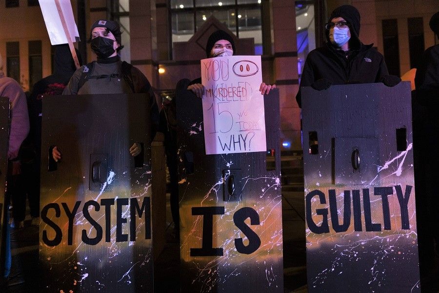 Black Lives Matter activists stand with shields outside of the Columbus Police Headquarters in reaction to the police shooting of a teenage girl on 20 April 2021 in Columbus, Ohio, US. (Stephen Zenner/Getty Images/AFP)