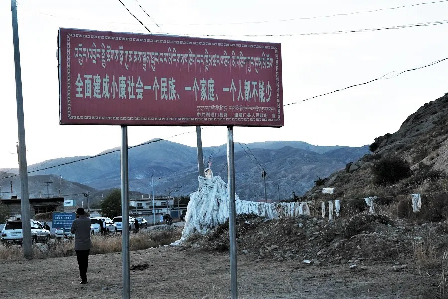A signboard with slogans of poverty alleviation work and building a moderately affluent society that includes all.