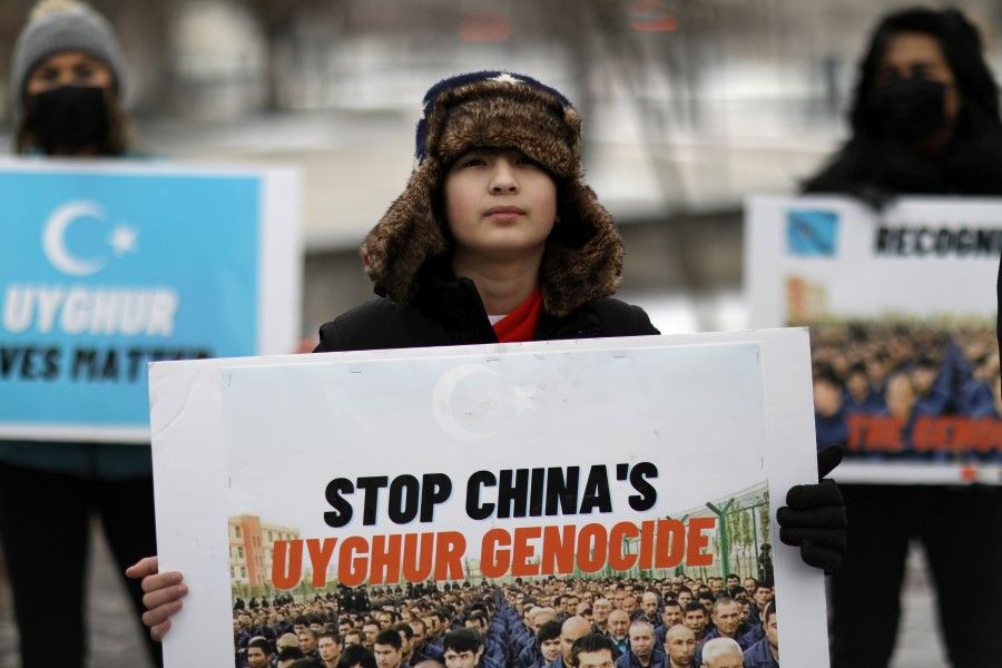 People take part in a rally to encourage Canada and other countries as they consider labeling China's treatment of its Uighur population and Muslim minorities as genocide, outside the Canadian Embassy in Washington, DC, US, 19 February 2021. (Leah Millis/Reuters)