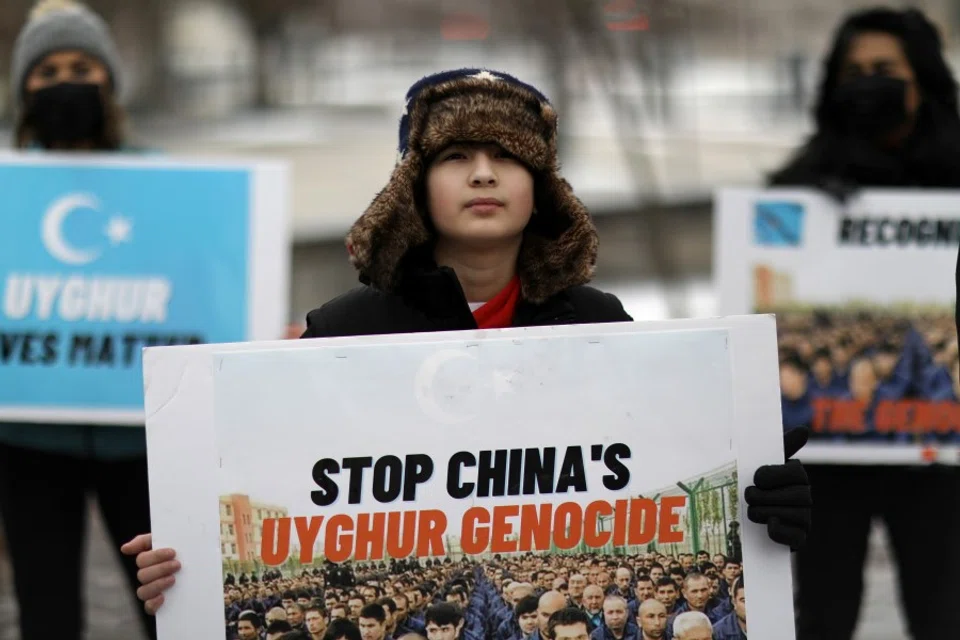 People take part in a rally to encourage Canada and other countries as they consider labeling China's treatment of its Uighur population and Muslim minorities as genocide, outside the Canadian Embassy in Washington, DC, US, 19 February 2021. (Leah Millis/Reuters)