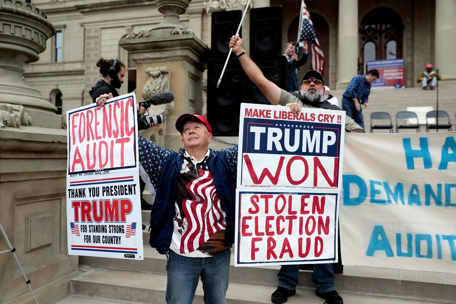 Supporters of former US President Donald Trump gather outside the Michigan State Capitol to demand an audit of 2020 election votes, in Lansing, Michigan, US, 12 October 2021. (Rebecca Cook/Reuters)