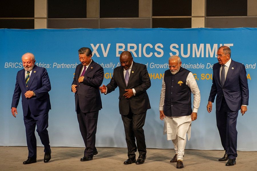(left to right) Brazil's President Luiz Inacio Lula da Silva, China's President Xi Jinping, South African President Cyril Ramaphosa, Indian Prime Minister Narendra Modi and Russia's Foreign Minister Sergei Lavrov walk after posing for a picture at the BRICS Summit in Johannesburg, South Africa, on 23 August 2023. (Alet Pretorius/Pool/Reuters)