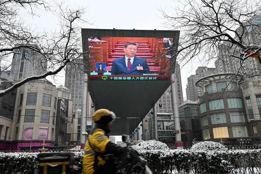 A screen shows Chinese President Xi Jinping during the opening session of the National People’s Congress at the Great Hall of the People, in Beijing on 5 March 2026.