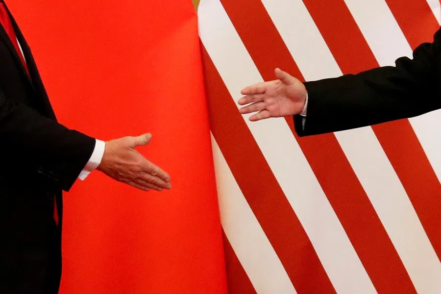 US President Donald Trump and China's President Xi Jinping shake hands after making joint statements at the Great Hall of the People in Beijing, China, on 9 November 2017.