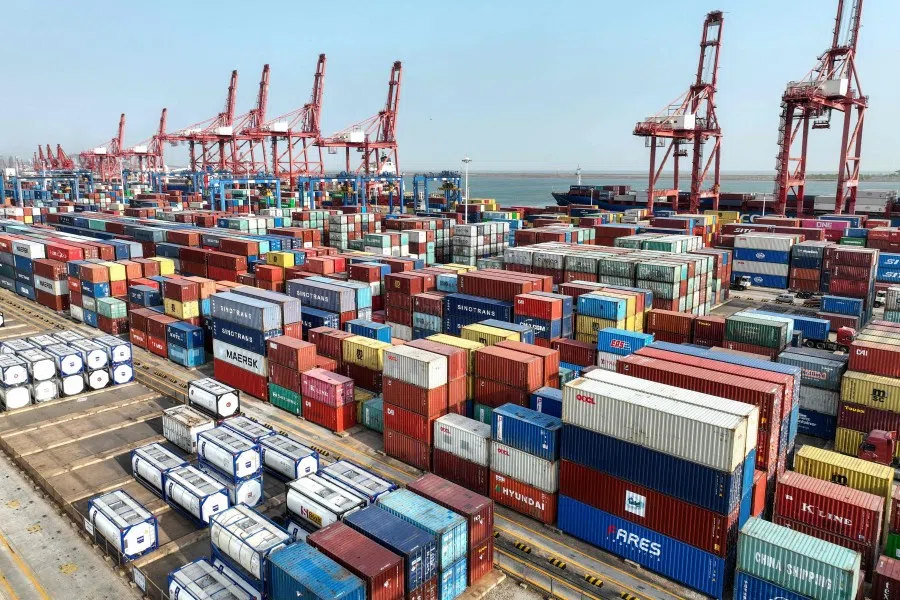 Cranes and shipping containers are seen at Lianyungang port in China's eastern Jiangsu province on 13 April 2023. (AFP)