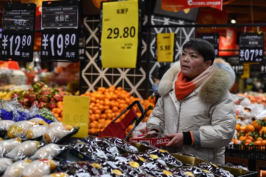 A customer shops for vegetables and fruit at a supermarket in Fuyang, in eastern China’s Anhui province on 8 February 2024. (AFP)
