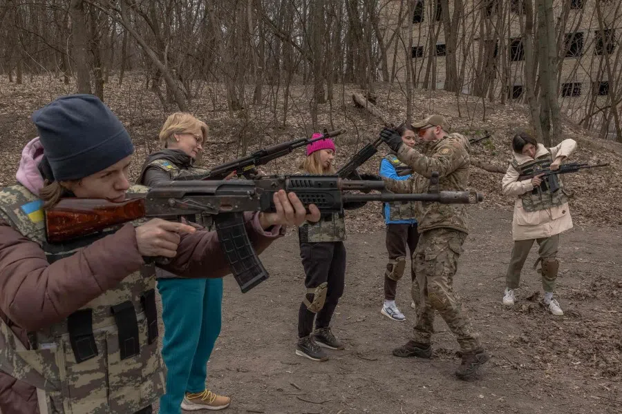 Ukrainian civilian women practice with weapons as they attend training for women focused on the use of weapons and combat medical kits, in Kyiv, on 16 March 2024, amid the Russian invasion of Ukraine. Organised by a civilian organisation Ukrainian Walkyrie the training teaches women basic knowledge about weapons and combat medical kits, as well as fundraises money for the Ukrainian army. (Roman Pilipey/AFP)