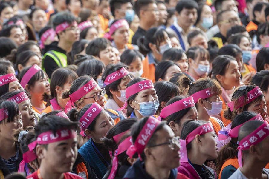 Employees attend a pep rally in the yard of a Cainiao warehouse, the logistics subsidiary of Alibaba Group Holding Ltd., ahead of the company's annual Singles' Day shopping extravaganza in Wuxi, Jiangsu province, China, on 9 November 2020. (Qilai Shen/Bloomberg)