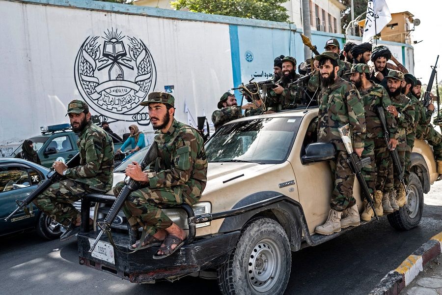 Armed Taliban security personnel ride a vehicle convoy as they parade near the US embassy in Kabul, Afghanistan on 15 August 2023, during the second anniversary celebrations of their takeover. (Wakil Kohsar/AFP)