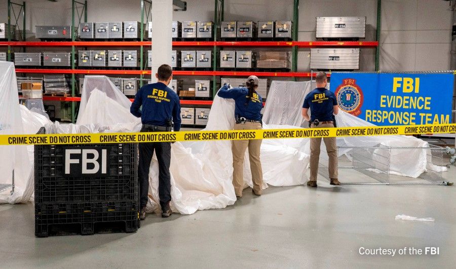 FBI Special Agents assigned to the bureau's Evidence Response Team process material recovered from the high-altitude Chinese balloon that was shot down by a US military jet off the coast of South Carolina, in this image released by the FBI on 9 February 2023. (FBI/Handout via Reuters)