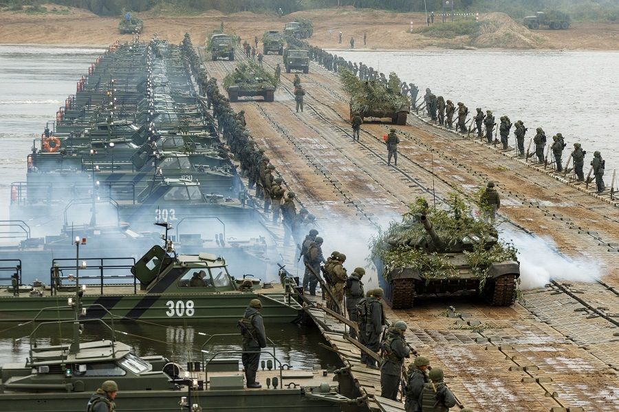 Service members transport tanks and trucks on a pontoon bridge across the Oka River during the active phase of the military exercises "Zapad-2021" staged by the armed forces of Russia and Belarus in Murom, Russia, 8 September 2021. The drills also involve military personnel from Armenia, India, Kazakhstan, Kyrgyzstan and Mongolia. (Vadim Savitskiy/Russian Defence Ministry Press Service/Handout via Reuters)