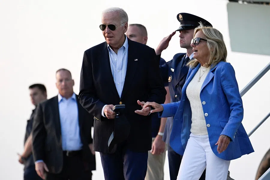 US President Joe Biden lends a hand to first lady Jill Biden as they disembark from Air Force One at Dover Air Force Base prior to departure for Rehoboth Beach in Delaware, US, on 25 August 2024. (Craig Hudson/Reuters)