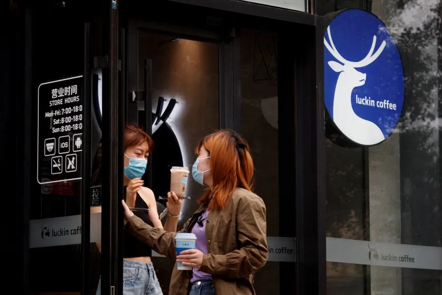 Women leave a store of the Chinese coffee house chain Luckin Coffee in Beijing, China, July 8, 2020. Picture taken 8 July 2020. (Reuters/Thomas Peter/File Photo)