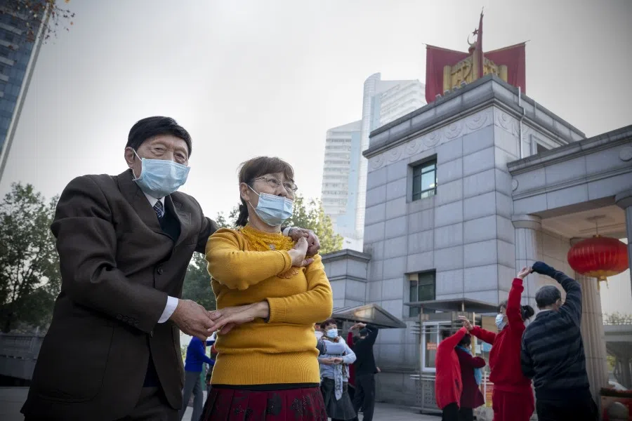 Visitors dance in a public park in Wuhan, Hubei Province, China, on 23 December 2021. (Andrea Verdelli/Bloomberg)