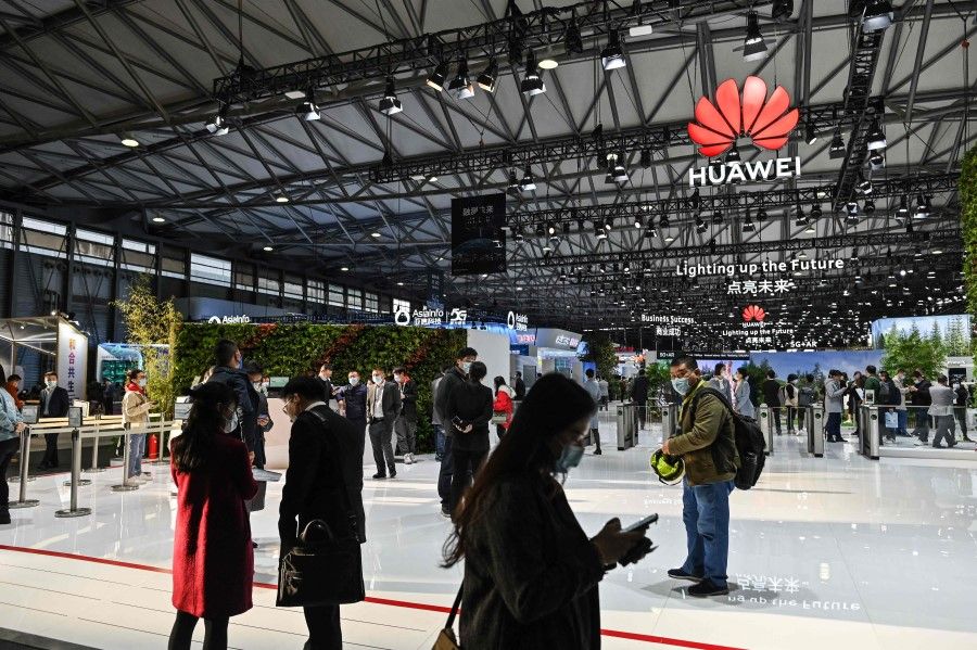 People visit a Huawei booth during the Mobile World Congress in Shanghai on 23 February 2021. (Hector Retamal/AFP)