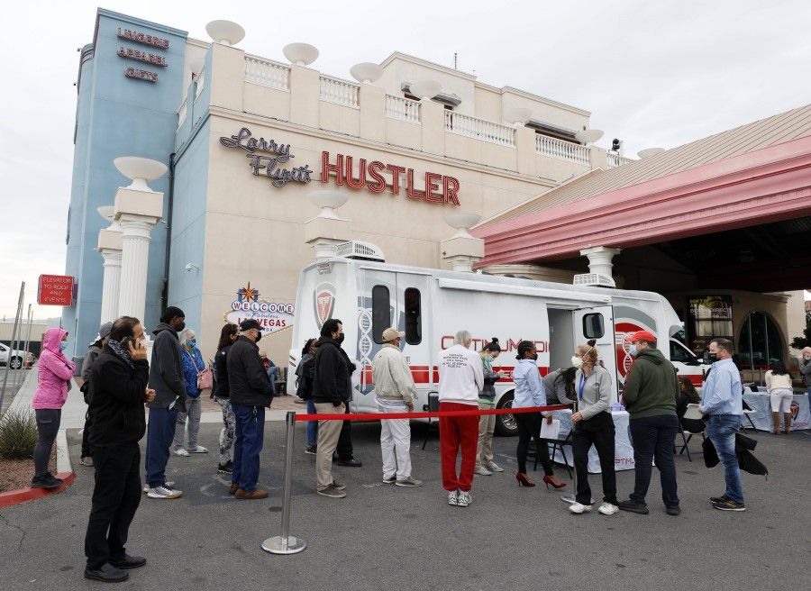 People line up at a pop-up Covid-19 vaccination clinic at Larry Flynt's Hustler Club on 21 December 2021 in Las Vegas, Nevada. (Ethan Miller/Getty Images/AFP)