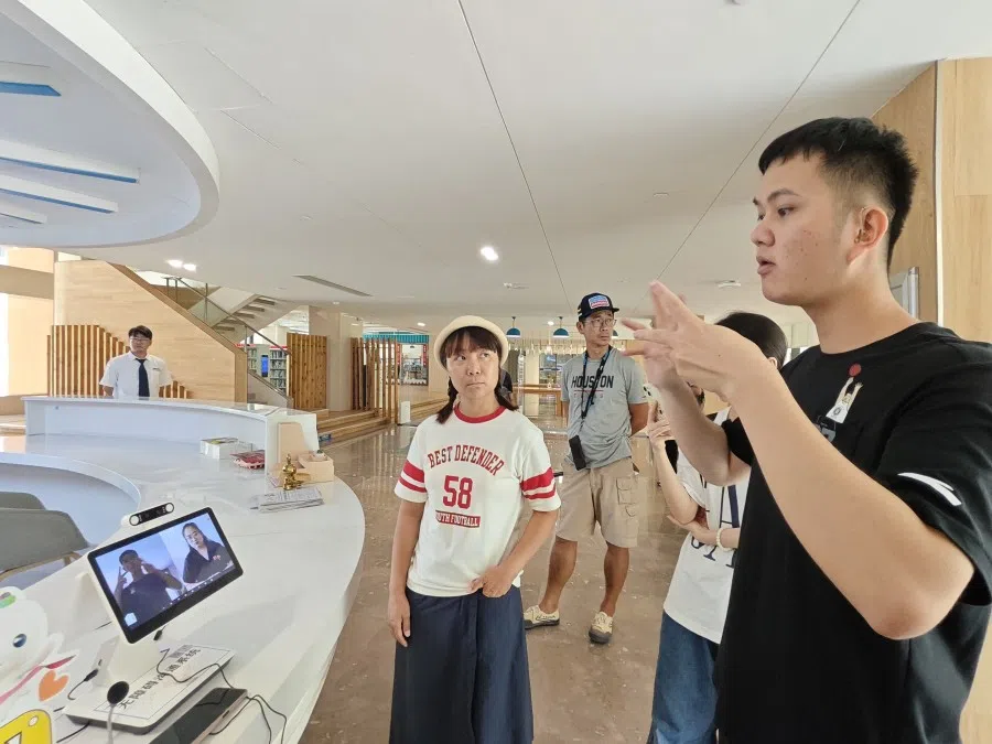 A hearing impaired person communicates through sign language interpretation.