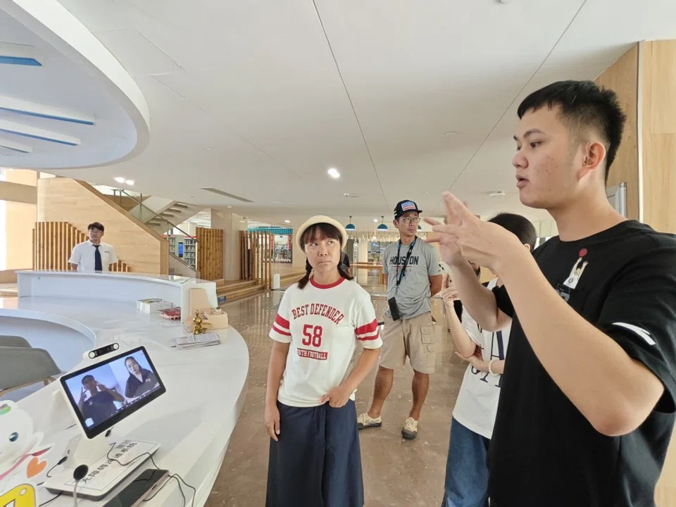 A hearing impaired person communicates through sign language interpretation.