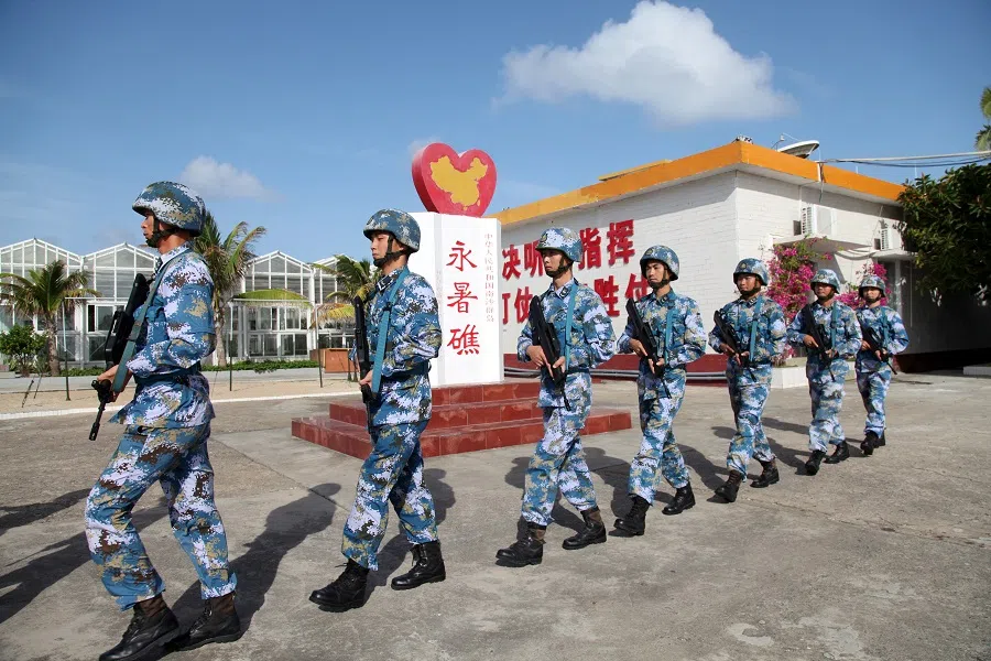 Soldiers of China's People's Liberation Army (PLA) Navy patrol at Fiery Cross Reef, in the Spratly Islands, on 9 February 2016. (Stringer/File Photo/Reuters)