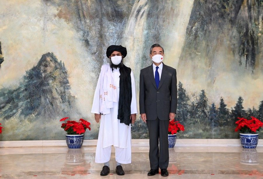 Chinese State Councilor and Foreign Minister Wang Yi meets with Mullah Abdul Ghani Baradar, political chief of Afghanistan's Taliban, in Tianjin, China, 28 July 2021. (Li Ran/Xinhua via Reuters)