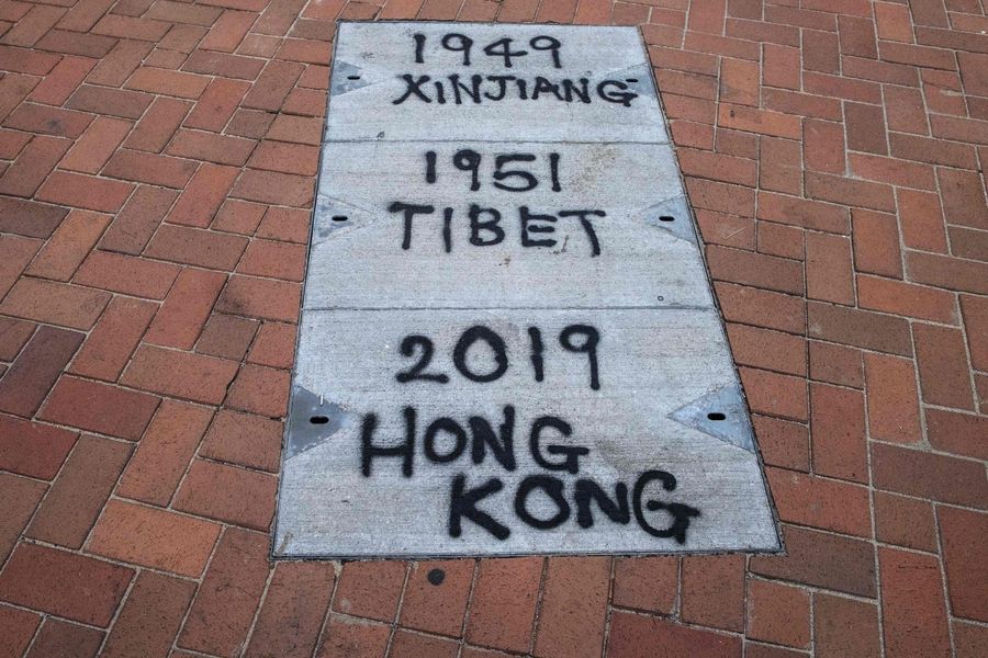 Graffiti relating to Xinjiang and Tibet is seen on the pavement during a rally in Hong Kong on 22 December 2019 to show support for the Uighur minority in China. (Anthony Wallace/AFP)