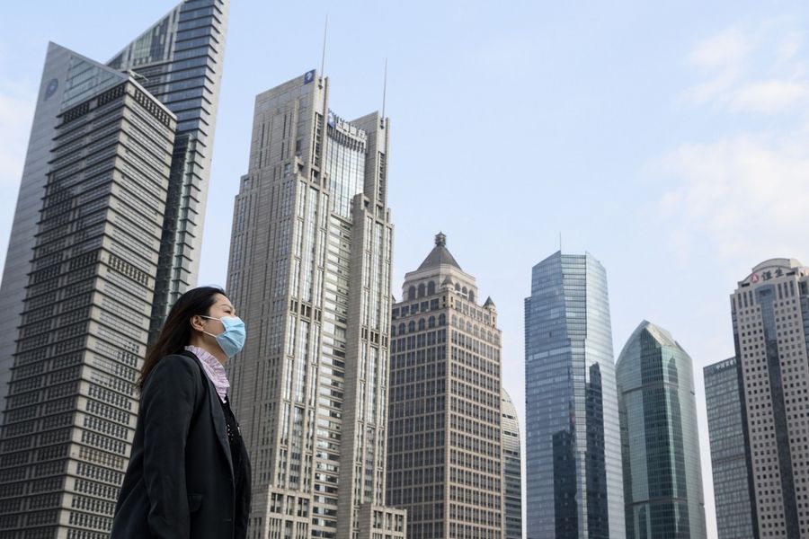 As the world's second largest economy, China should have gained enough confidence to not be affected by terms like "sick man of Asia". In this photo taken on 25 February 2020, a woman wearing a protective face mask walks on an overpass in Shanghai. (Noel Celis/AFP)