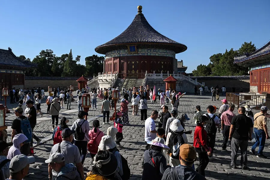 People visit the Imperial Vault of Heaven at the Temple of Heaven in Beijing on 14 May 2024.  (Hector Retamal/AFP)