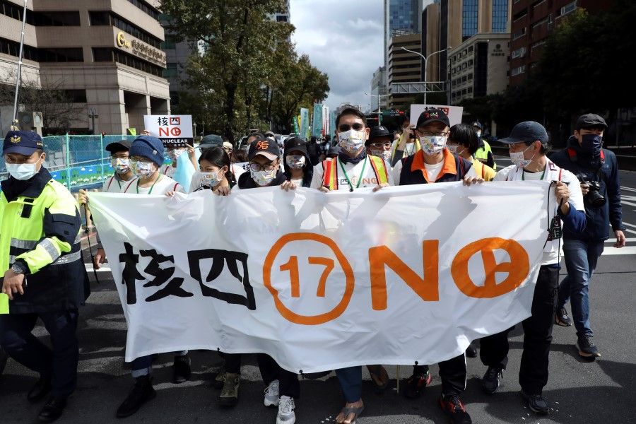 Demonstrators take part in a march against nuclear power ahead of a referendum on whether the government should continue building the stalled Fourth Nuclear Power Plant, in Taipei, Taiwan, 5 December 2021. (Annabelle Chih/Reuters)