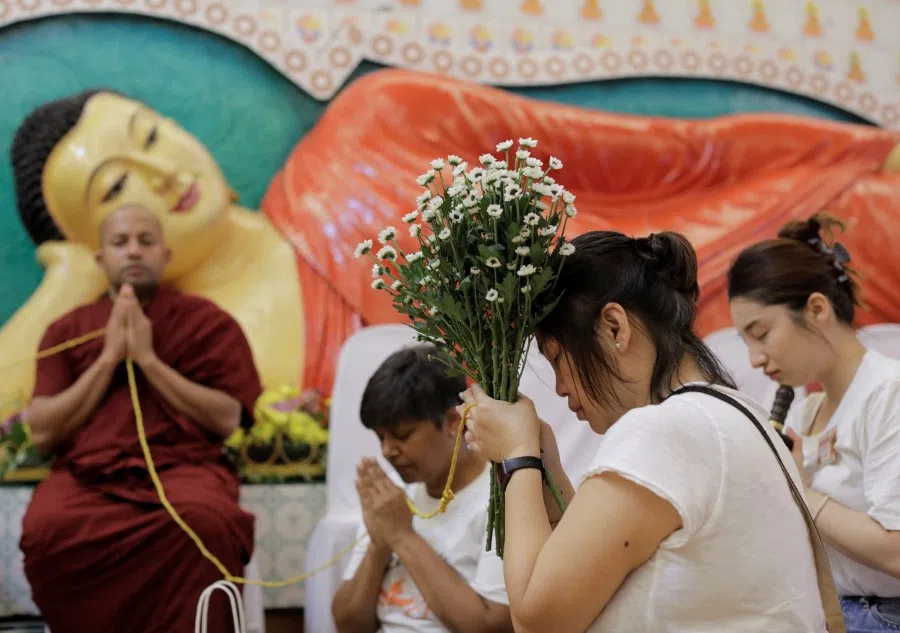 Devotees pray on the eve of Vesak day, an annual celebration of Buddha's birth, enlightenment and death, at Buddhist Maha Vihara temple in Kuala Lumpur, Malaysia, 3 May 2023. (Hasnoor Hussain/Reuters)