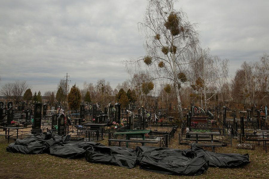Bodies of civilians, collected from streets to the local cemetery, are seen, as Russia's attack on Ukraine continues, in the town of Bucha, outside Kyiv, Ukraine, 6 April 2022. (Oleg Pereverzev/Reuters)