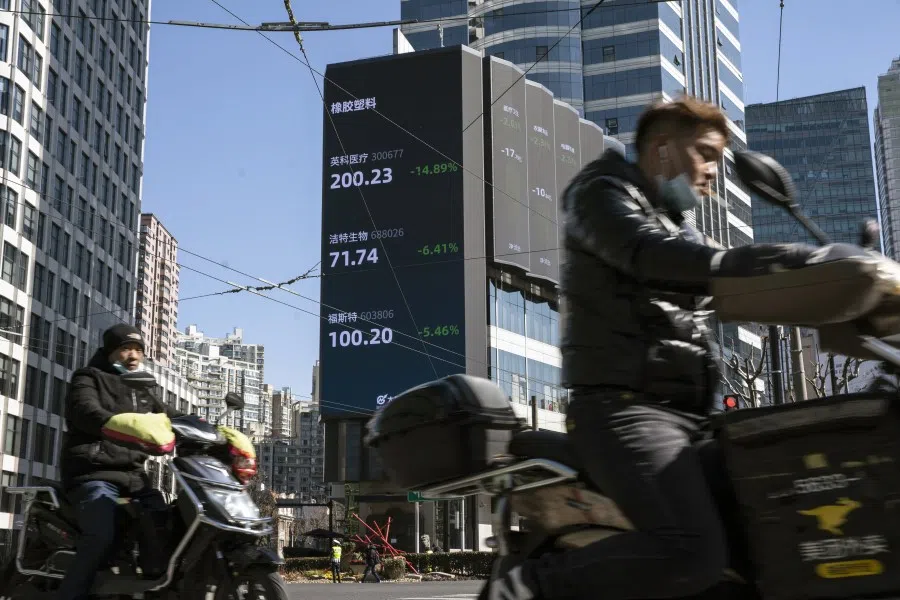 Motorists travel past a screen displaying stock figures in Shanghai, China, on 18 February 2021. (Qilai Shen/Bloomberg)
