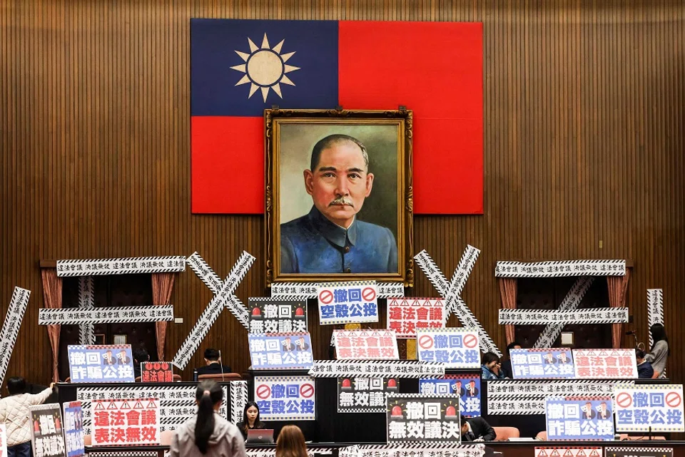 Banners reading Illegal meeting, invalid resolution are plastered throughout the Legislative Yuan chamber in Taipei on 28 March 2025. (I-Hwa Cheng/AFP)