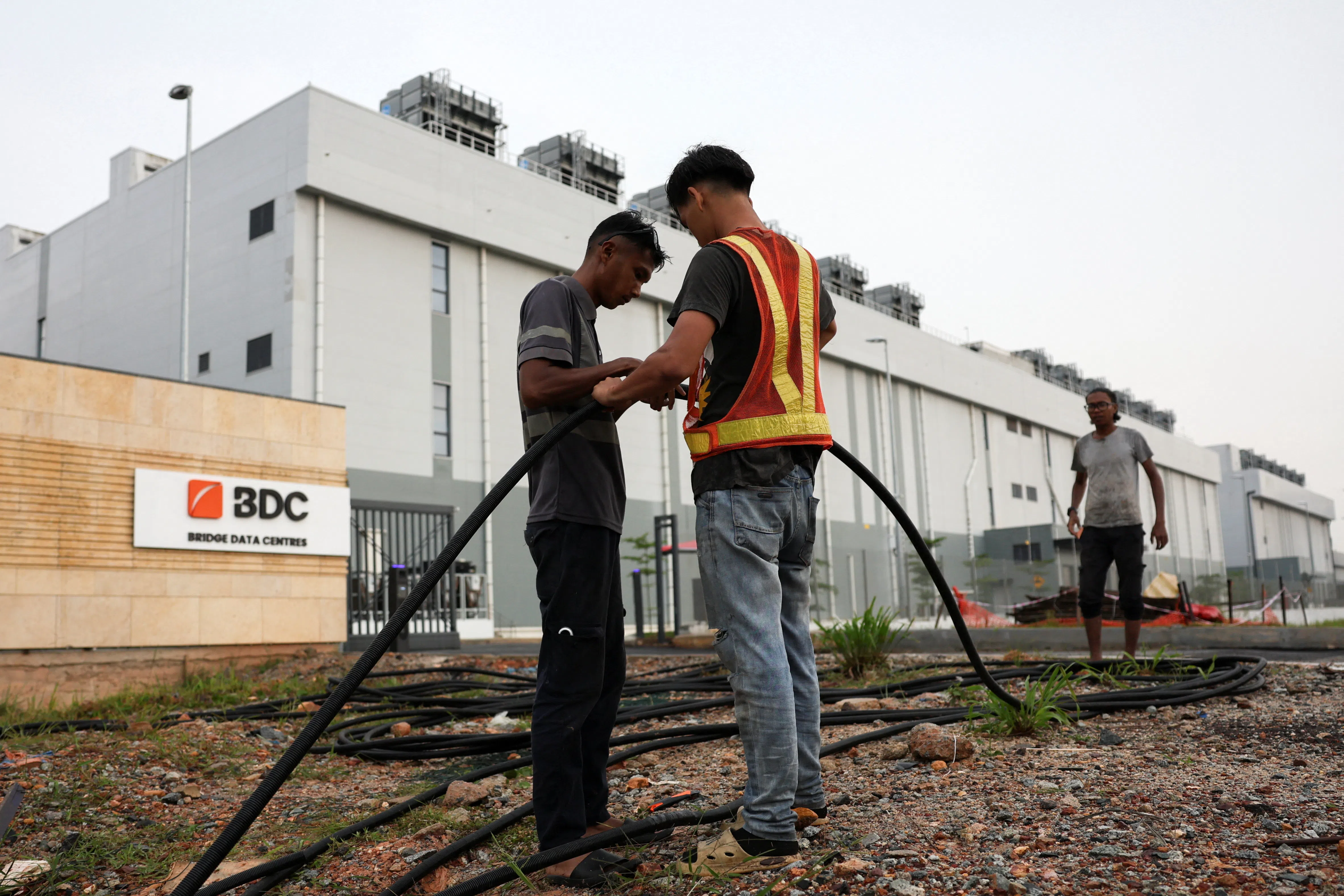 Workers laying cables outside Bridge Data Centres in Johor state, at Sedenak, Malaysia, on 6 May 2026.