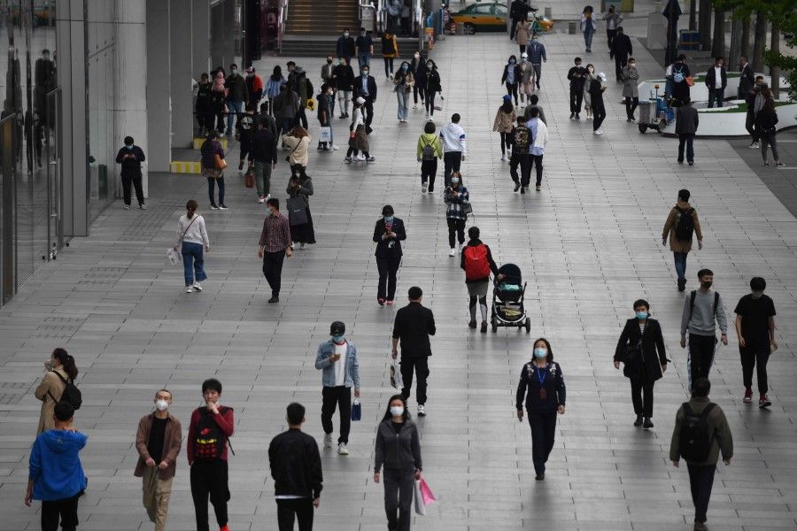 People outside a shopping mall in Beijing, April 17, 2020. (Greg Baker/AFP)