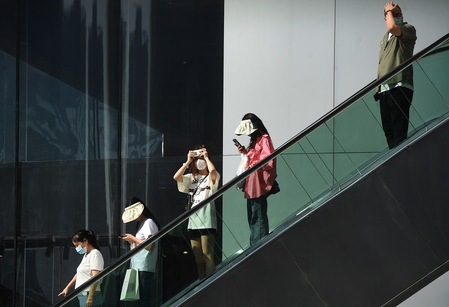 People ride on an escalator in Chongqing, China, 10 May 2022. (CNS)