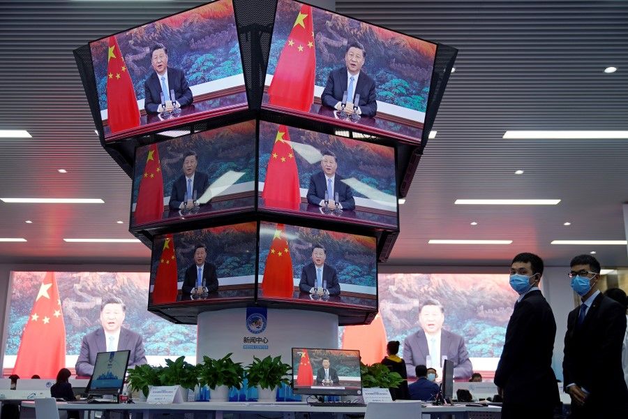 China's President Xi Jinping is seen on screens in the media center as he speaks at the opening ceremony of the third China International Import Expo (CIIE) in Shanghai, 4 November 2020. (Aly Song/REUTERS)