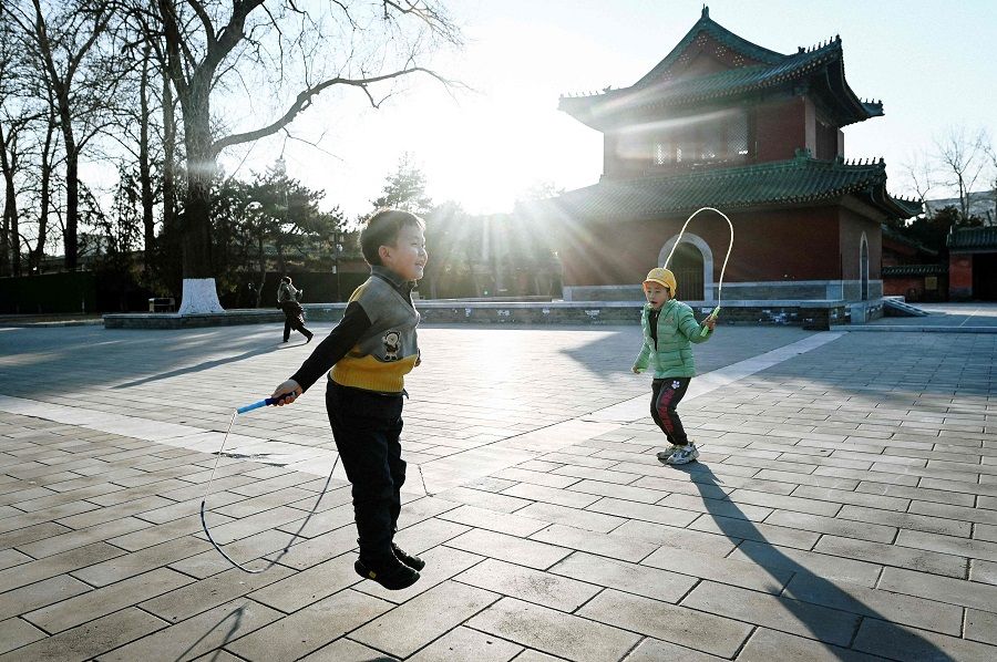 Children having fun at a park in Beijing, China, on 11 January 2022. (Wang Zhao/AFP)