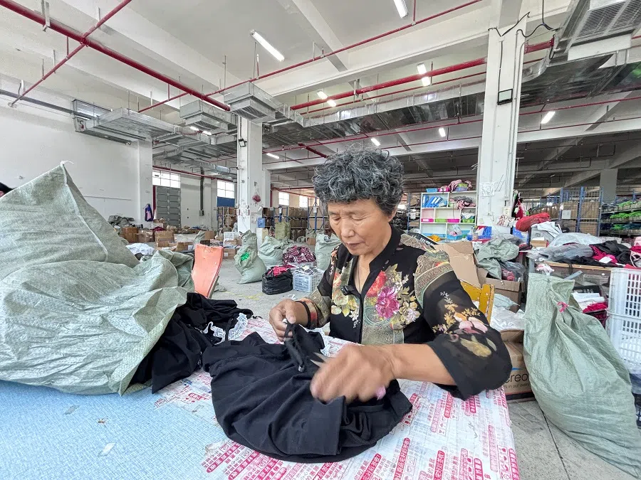 An employee working on a garment at Lei’s lingerie factory.