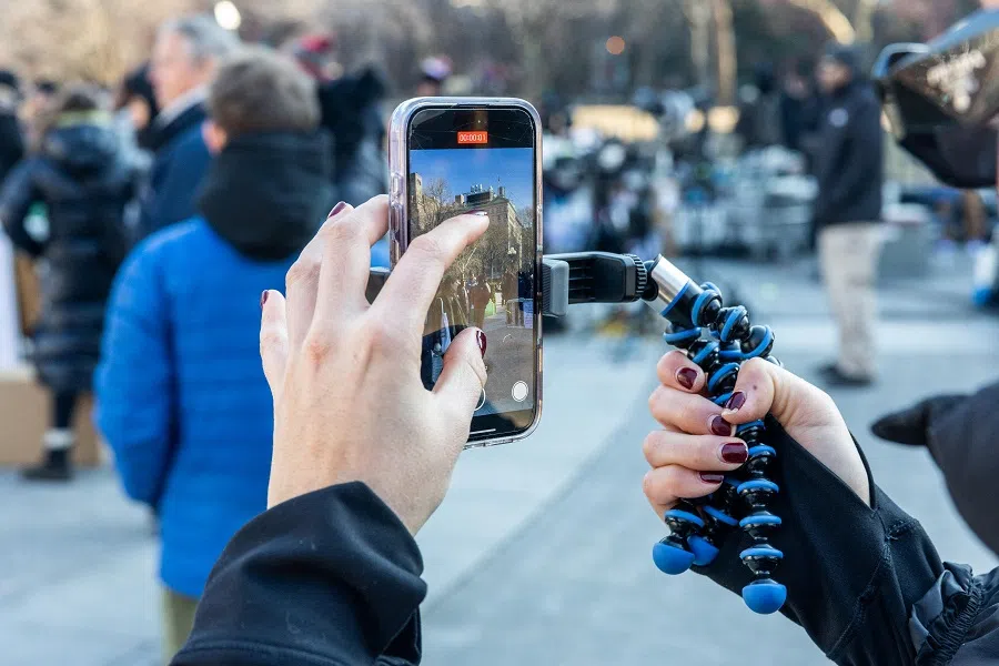 A representative for Discovering Artists conducts interviews at Washington Square Park for their TikTok and Instagram reels on 17 January 2025 in New York City. (Alex Kent/Getty Images via AFP)