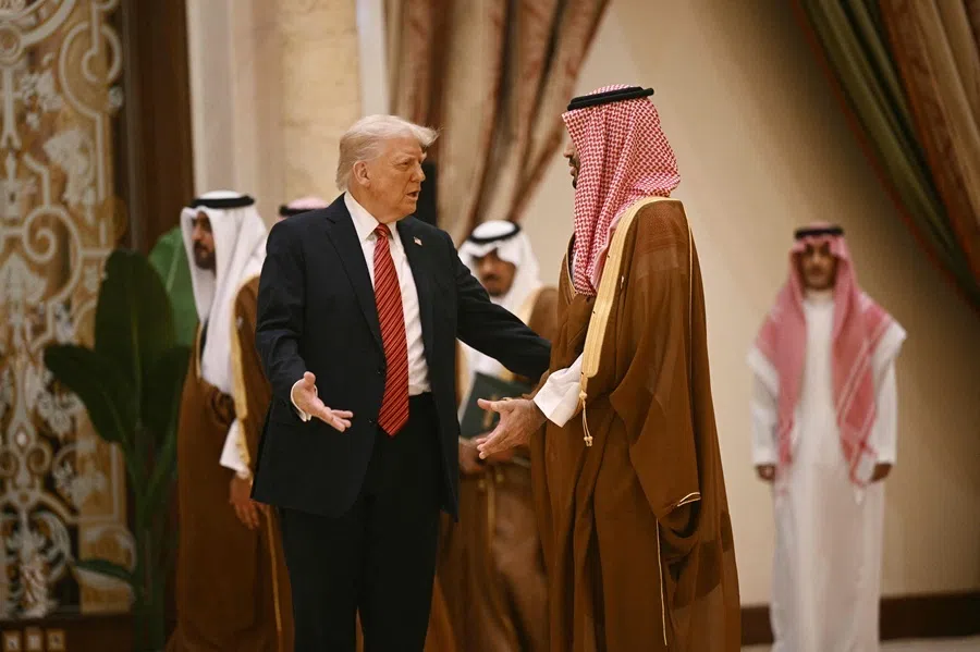 US President Donald Trump speaks with Saudi Crown Prince Mohammed bin Salman before posing for a family picture with Gulf leaders during a gathering of the six-nation Gulf Cooperation Council (GCC) in Riyadh on 14 May 2025.