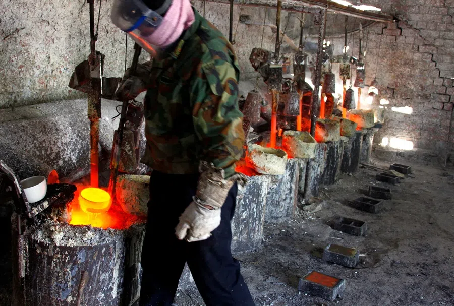 Ren Limin, a worker at the Jinyuan Company’s smelting workshop, prepares to pour the rare earth metal Lanthanum into a mould near the town of Damao in China’s Inner Mongolia Autonomous Region on 31 October 2010. (David Gray/Reuters)