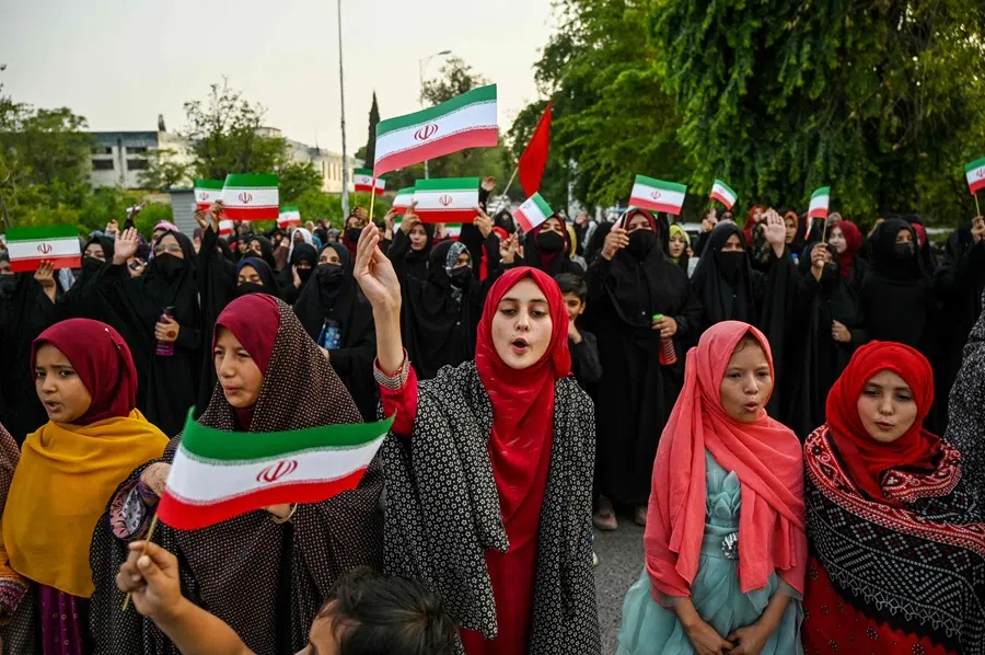 Shiite Muslim women from the Majlis Wahdat-e-Muslimeen (MWM) hold Iranian flags as they shout slogans during an anti-Israel protest in Islamabad, on 17 June 2025, amid the ongoing conflict between Israel and Iran. (Aamir Qureshi/AFP)