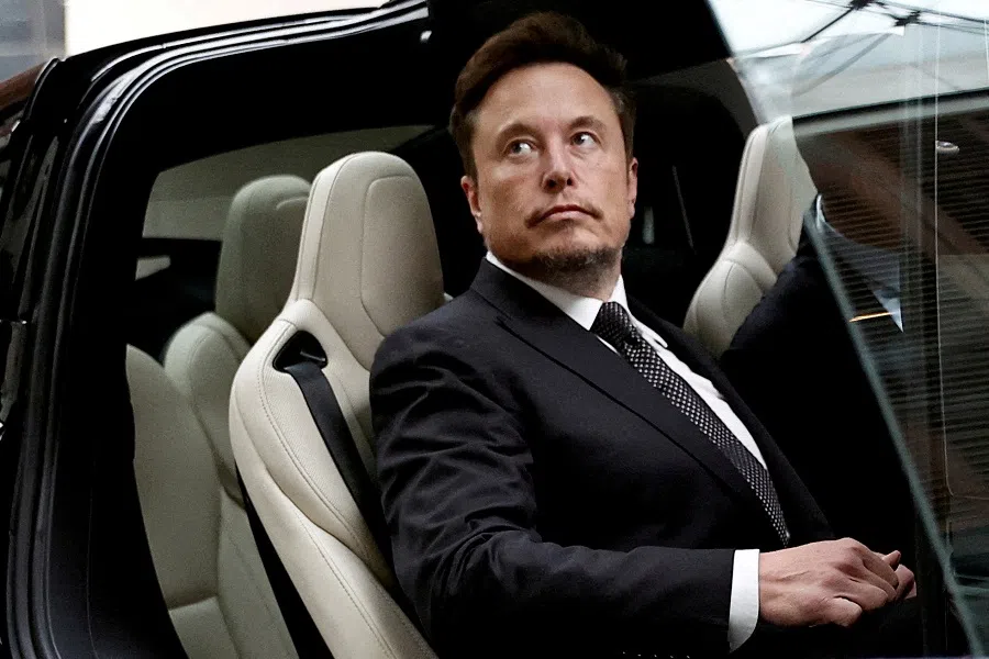 Tesla CEO Elon Musk gets in a Tesla car as he leaves a hotel in Beijing, China, on 31 May 2023. (Tingshu Wang/Reuters)