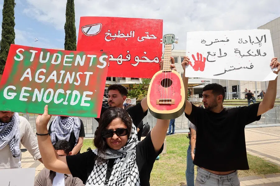 Arab-Israeli students and left-wing Israeli activists wave placards during the “Nakba Remembrance Day” ceremony at the Tel Aviv University campus in Tel Aviv on 14 May 2025. Palestinians mark the Nakba, or “catastrophe” of the creation of Israel, which sparked the exodus of hundreds of thousands of Palestinians. (Jack Guez/AFP)