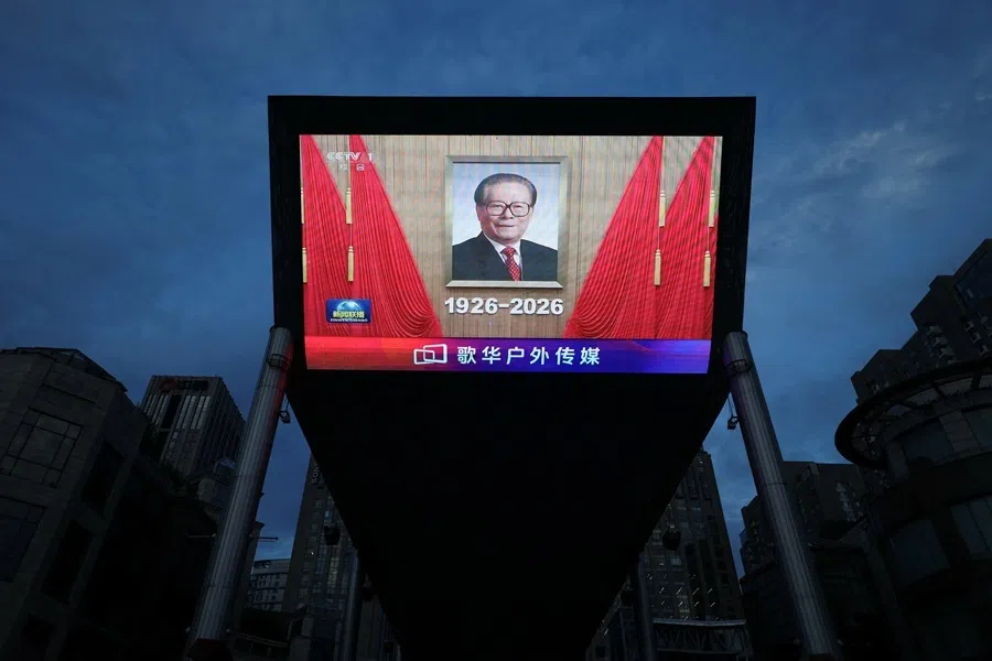 A giant screen shows a news footage of a portrait of late leader Jiang Zemin during an event commemorating his 100th birth anniversary, in Beijing, China, on 17 August 2026.