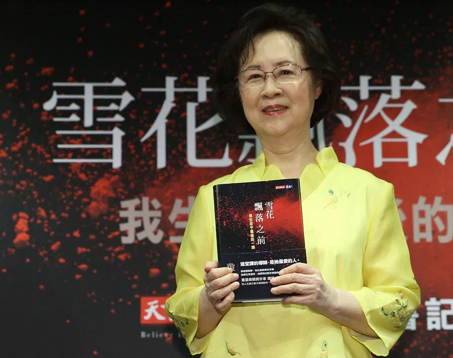 This picture taken by Taiwan’s Central News Agency on 1 August 1 2017 shows Taiwanese writer Chiung Yao posing with her new book at a book release event in Taipei.
