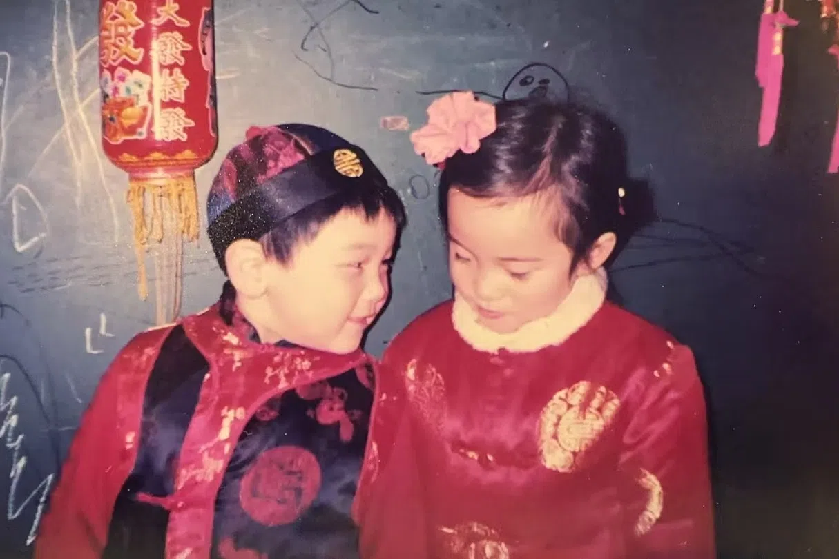 A photo of the author (left) when he was a kid, celebrating Chinese New Year with his friend.