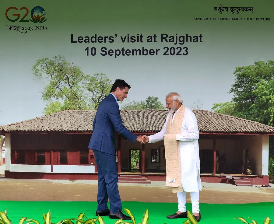 India's Prime Minister Narendra Modi (right) and his Canadian counterpart Justin Trudeau shake hands upon their arrival before paying respect at the Mahatma Gandhi memorial at Raj Ghat on the sidelines of the G20 summit in New Delhi, India, on 10 September 2023. (PIB/AFP)