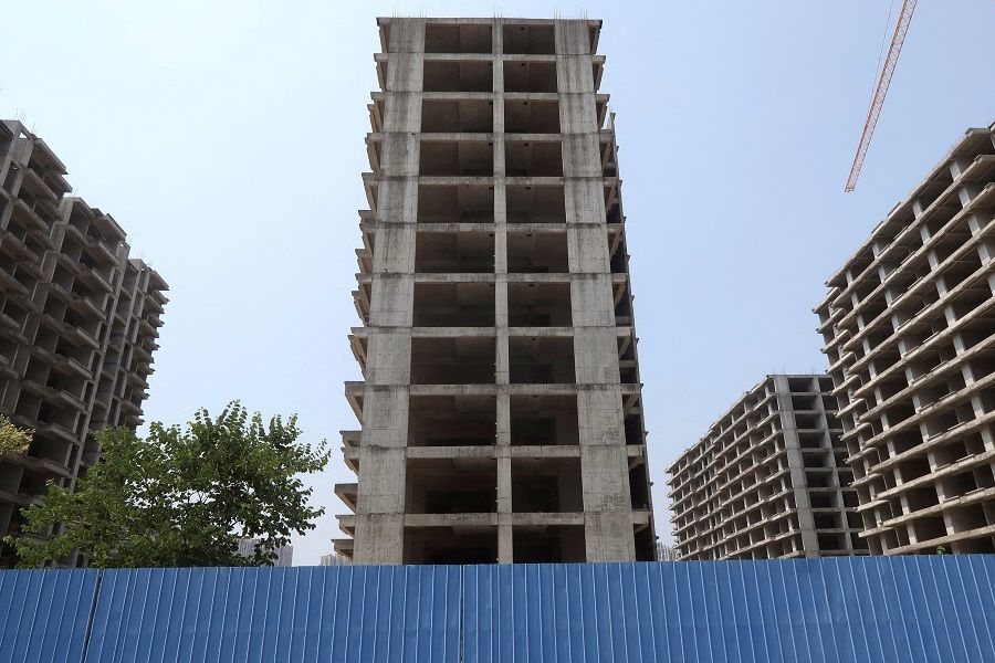 Unfinished apartment buildings stand at a residential complex in Guilin, Guangxi Zhuang Autonomous Region, China, 17 September 2022. (Eduardo Baptista/File Photo/Reuters)