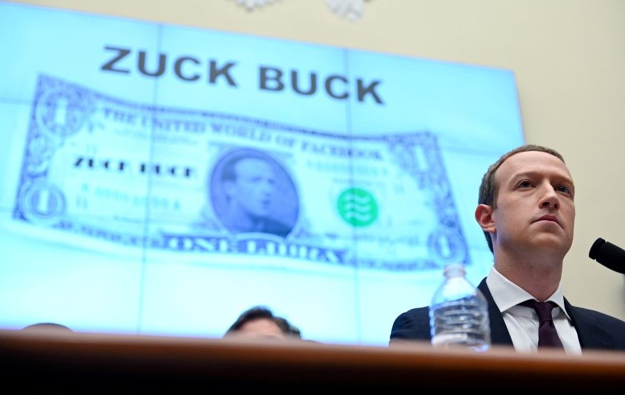 Facebook Chairman and CEO Mark Zuckerberg testifies in front of a projection of a "Zuck Buck" at a House Financial Services Committee hearing examining the company's plan to launch a digital currency on Capitol Hill in Washington, U.S., 23 October 2019. (Erin Scott/REUTERS)